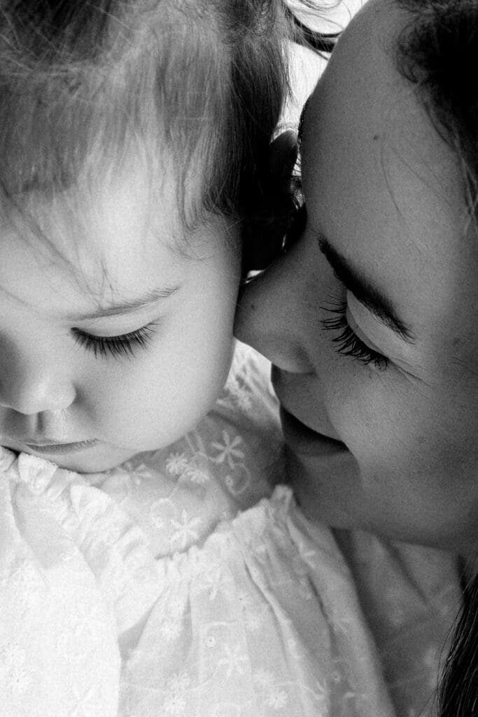 Emotive black and white close up of mother and baby connection