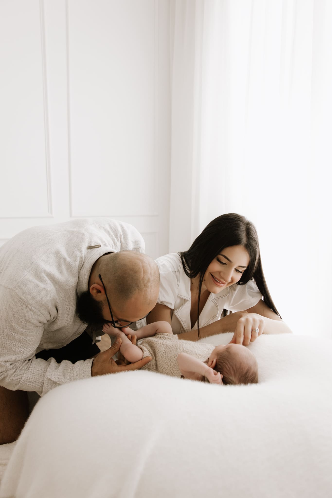 parents interacting with newborn during relaxed family session newborn photographer Sydney studio